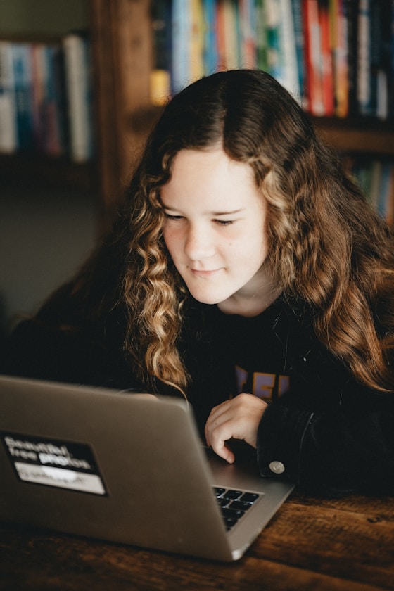 A girl looking at a laptop