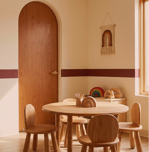 A child-friendly therapy room with a round table, chairs and wooden toys at Hiba by Anthalora
