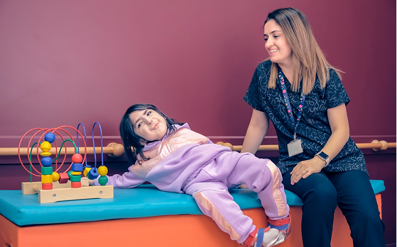 A speech and language therapist working with a child at Hiba
