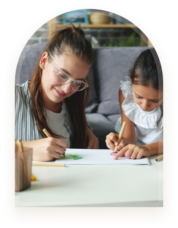 A mother and daughter drawing together at home