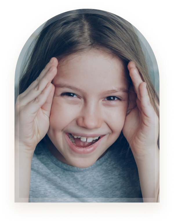 A girl smiling with her hands on her head