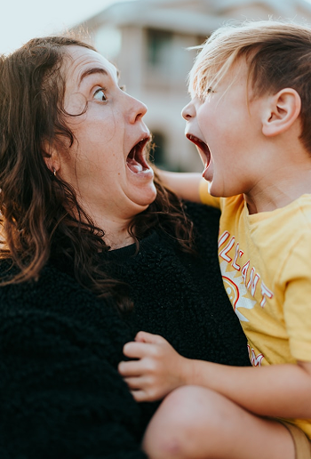 A mother and child laughing together