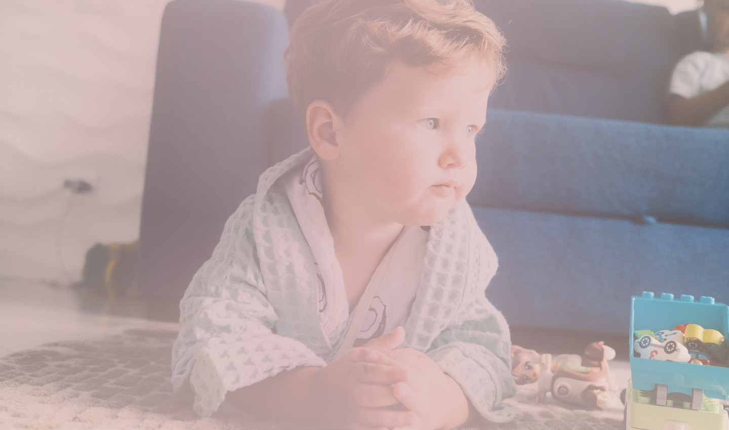 A baby playing on the floor with toys at home