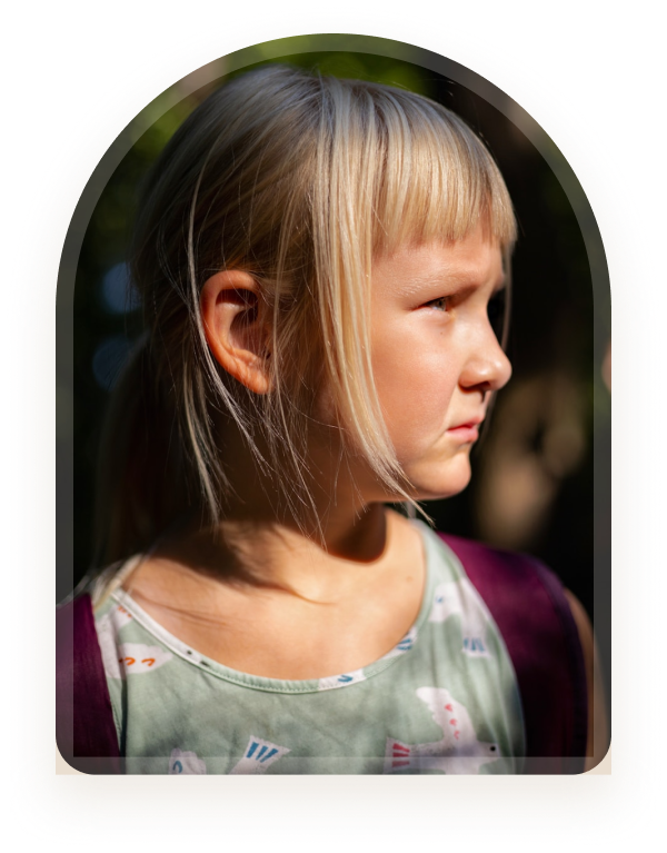 A girl looking to the side with sunlight on her face