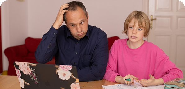 A parent and child working together at a table during a memory skills workshop
